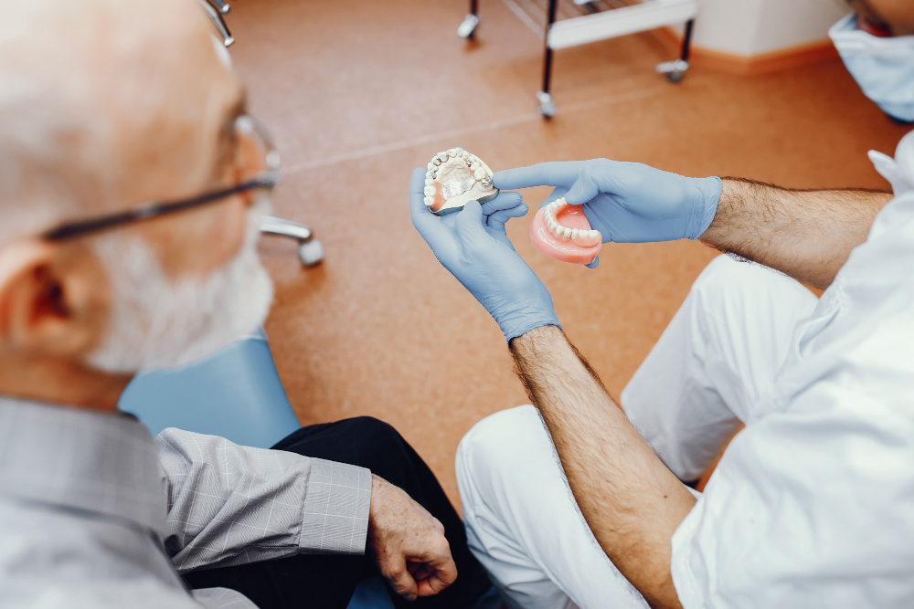 Patient finding the difference between dental implants and dentures.