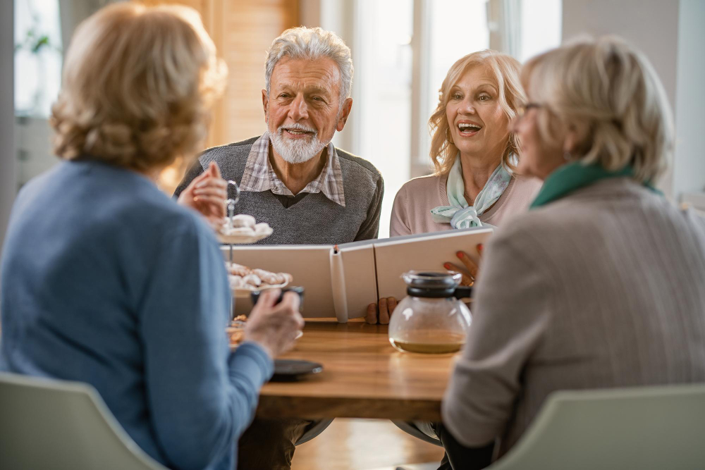 Older people at dinner talking about dental implants, smiling and having a good time.