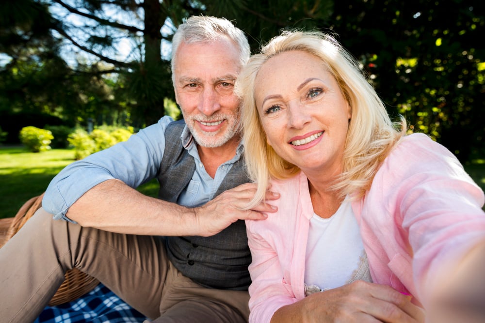 Couple smiling with great teeth showing it's not too late to get dental implants.